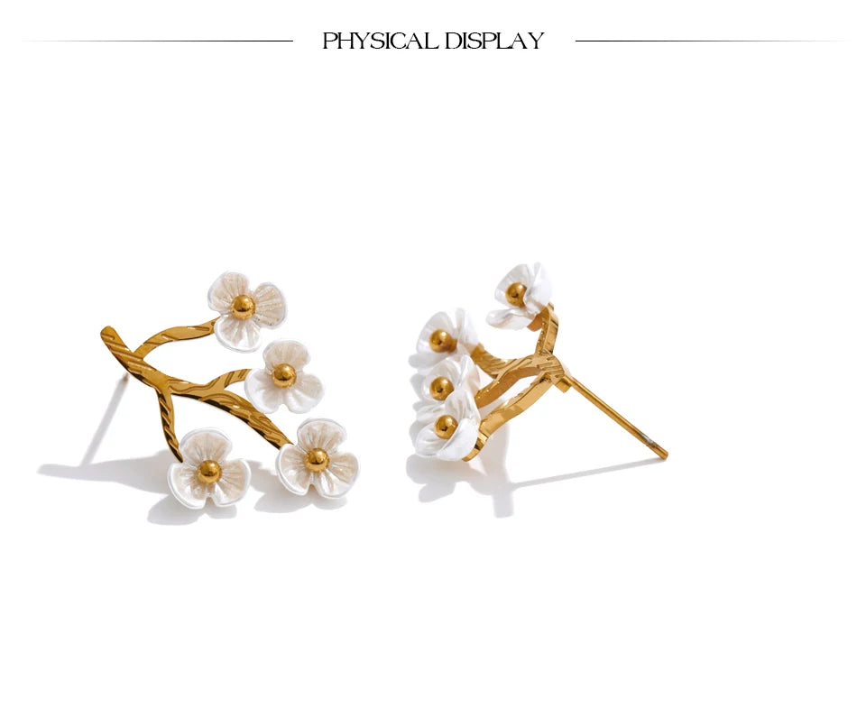 Two studded abstract tree earrings turned sideways in white background and shadows